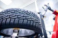 Close-up winter car tire with steel studs in service on machine tool