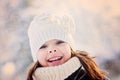 Close up winter portrait of adorable happy child girl in snowy forest