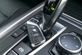 Close up of wireless keys of BMW X5 F15 2017 in black leather car interior. Modern Car interior details. Royalty Free Stock Photo