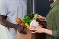 Close up of woman accepting fresh grocery delivery