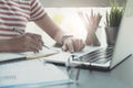 Close up of woman or accountant hand holding pen working on laptop computer for calculate business data, accountancy document and Royalty Free Stock Photo