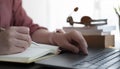 Close up of woman or accountant hand holding pencil working on calculator to calculate financial data report, accountancy document Royalty Free Stock Photo