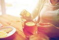 Close up of woman adding ginger to tea with lemon Royalty Free Stock Photo