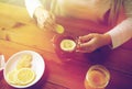 Close up of woman adding ginger to tea with lemon Royalty Free Stock Photo