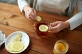 Close up of woman adding ginger to tea with lemon Royalty Free Stock Photo