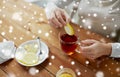 Close up of woman adding honey to tea with lemon Royalty Free Stock Photo