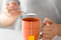 Close up of woman adding sugar to cup of tea Royalty Free Stock Photo