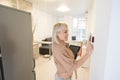 Close Up Of Woman Adjusting Central Heating Temperature At Home On Thermostat. Royalty Free Stock Photo