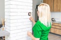 Close Up Of Woman Adjusting Wall Mounted Digital Central Heating Thermostat Control At Home Royalty Free Stock Photo