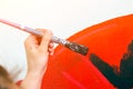 Woman paint little car Royalty Free Stock Photo