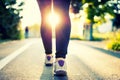 Close-up of woman athlete feet and shoes while running in park