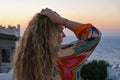 Close up of woman from back with hand in hair watching sunset and sea view from terrace of luxury holiday villa Royalty Free Stock Photo