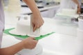 Close Up Of Woman In Bakery Decorating Cake With Royal Icing Royalty Free Stock Photo