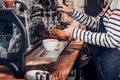 Close up woman barista making hot coffee with machine at counter Royalty Free Stock Photo