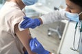 Close up of woman being vaccinated in a doctor`s office