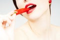 Close-up of a woman biting a chili pepper Royalty Free Stock Photo