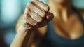 A close up of a woman in black tank top fist raised, AI