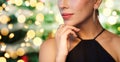 Close up of woman in black wearing diamond jewelry