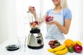 Close up of woman with blender making fruit shake Royalty Free Stock Photo