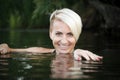 Close-up of a woman blonde middle-aged swims in the river, selective focus Royalty Free Stock Photo