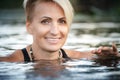 Close-up of a woman blonde middle-aged swims in the river, selective focus Royalty Free Stock Photo