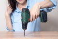 Close up woman assembling furniture with a screwdriver