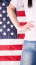 Close up of woman body and hand against american flag at 4th july. Faceless. Independence day, celebration, patriotism and