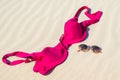 Close up of woman bra and glasses on the sand. Concept of sunbathing naked on the nude beach. Naturalist lifestyle. Nobody