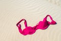 Close up of woman bra at nude beach. Concept of sunbathing naked on the sandy ocean beach. Naturalist lifestyle. Nobody