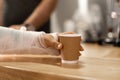 Close-up of a woman with a broken arm in a cast taking coffee to go in a cafe Royalty Free Stock Photo