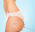 Close up of woman buttocks and magnifier Royalty Free Stock Photo