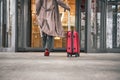 Close up of woman carrying suitcase at the airport terminal Royalty Free Stock Photo