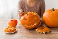 Close up of woman carving halloween pumpkin Royalty Free Stock Photo