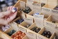 Close Up Of Woman Choosing Healing Crystals In Shop