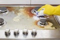 Close up of woman cleaning cooker at home kitchen Royalty Free Stock Photo