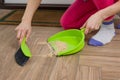 Close-up of woman cleaning floor with broom and dust pan Royalty Free Stock Photo