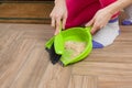 Close-up of woman cleaning floor with broom and dust pan Royalty Free Stock Photo