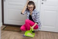 Close-up of woman cleaning floor with broom and dust pan Royalty Free Stock Photo