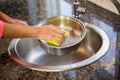 Close up of woman cleaning pot Royalty Free Stock Photo