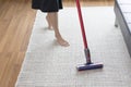 Woman cleaning rug carpet with vacuum cleaner at home Royalty Free Stock Photo