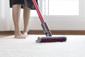 Woman cleaning rug carpet with vacuum cleaner at home Royalty Free Stock Photo