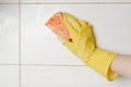 Close-up woman cleaning tiled surface in kitchen. Royalty Free Stock Photo