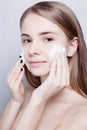 Close-up woman clears skin foam on gray background Royalty Free Stock Photo