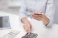 Close up of woman counting money with calculator Royalty Free Stock Photo