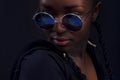 Close-up of woman with dark skin wearing round sunglasses Royalty Free Stock Photo