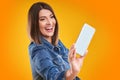 Close up of woman in denim jacket with smartphone over yellow background Royalty Free Stock Photo