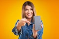 Close up of woman in denim jacket with smartphone over yellow background Royalty Free Stock Photo