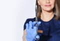 Close-up of woman dentists hand in glove with syringe full of anesthesia for pain relief injection before tooth curing