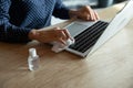 Close up of woman disinfect laptop with sanitizer