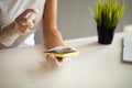 Close up woman disinfecting phone with antiseptic